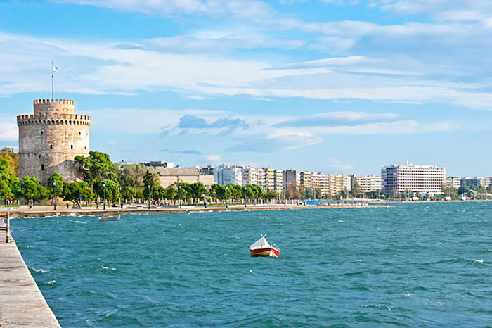Thessaloniki Greece travel guide – sunset view of White Tower and waterfront promenade with locals enjoying the Aegean coastline