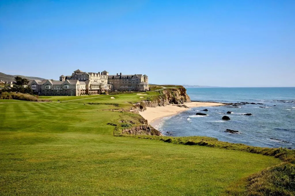 Half Moon Bay Travel Guide – Golden sand and rugged cliffs at Half Moon Bay State Beach during sunset
