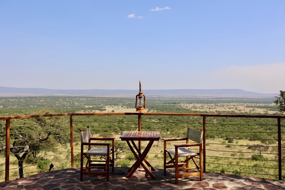 Couple enjoying wildlife views from private balcony on a Kenya safari tour for couples