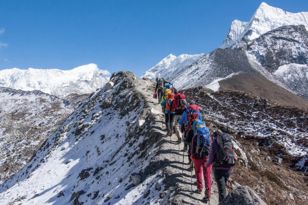 Group of trekkers hiking in the Himalayas β Ultimate trekking journey in Nepal Himalayas