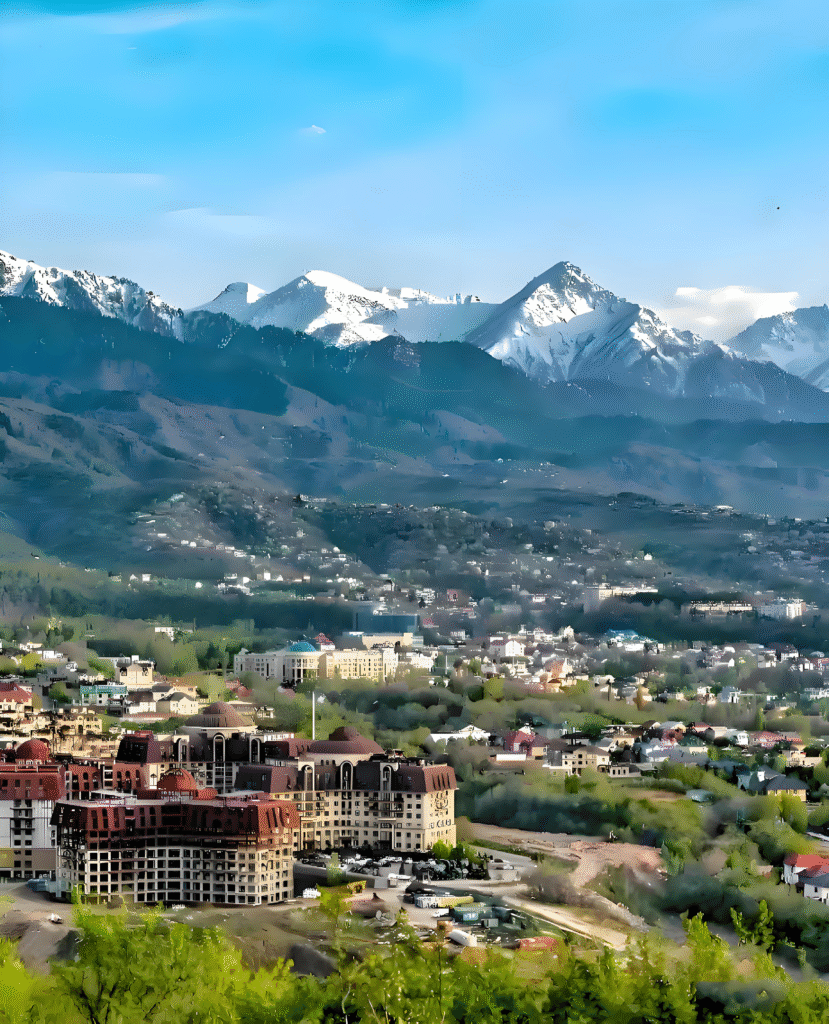 Mountain view of Almaty, Kazakhstan with modern cityscape in the foreground – adventurous cultural trip to Kazakhstan