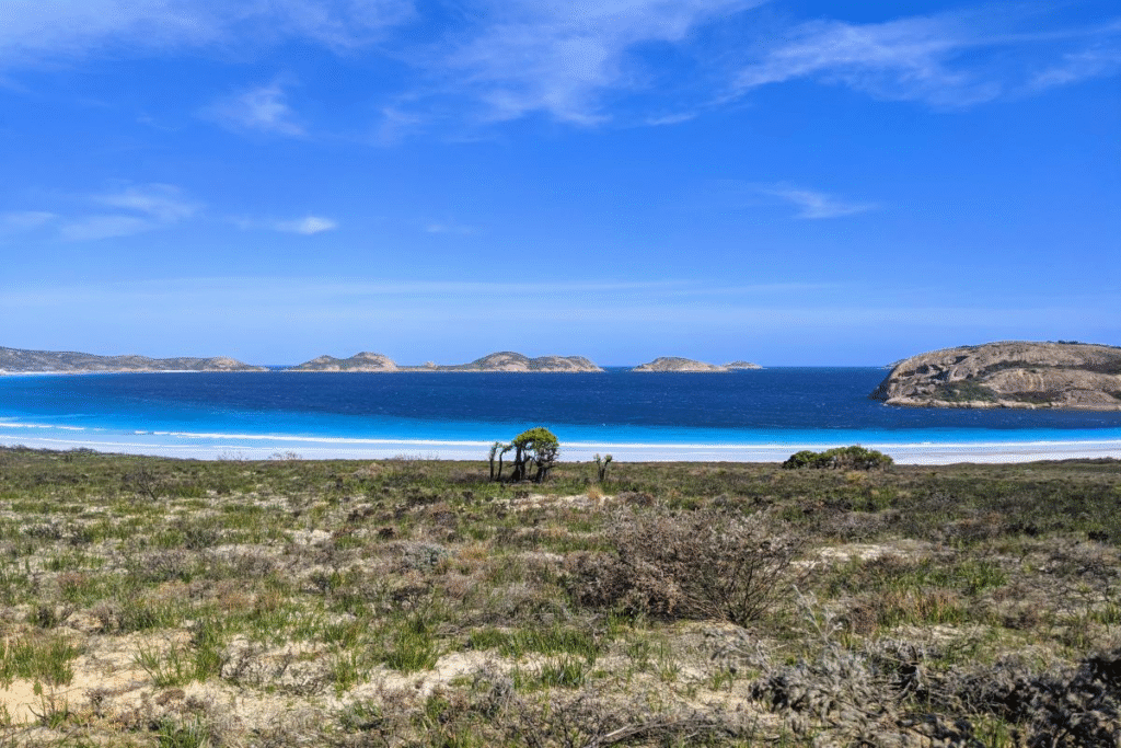 Hidden backtrack camping site at Lucky Bay in Western Australia, surrounded by white sand and turquoise ocean.