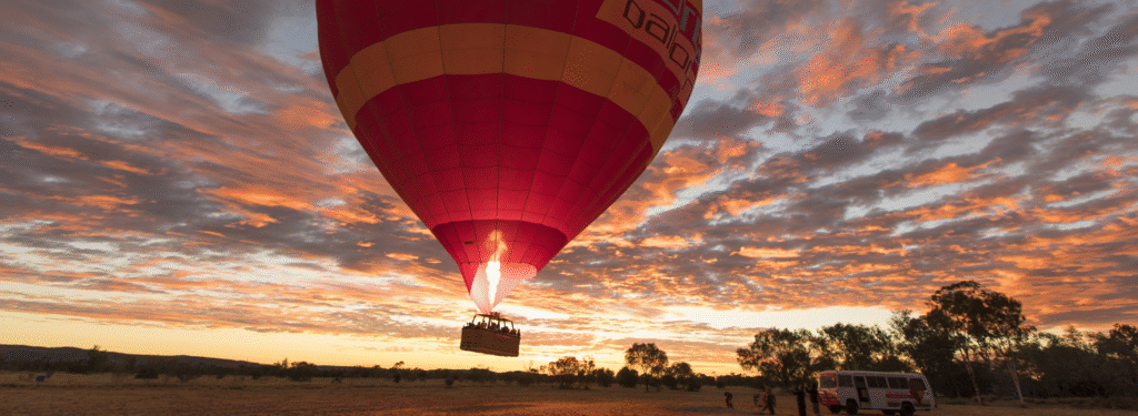 Hot air balloon Australia floating above the Red Centre and Uluru