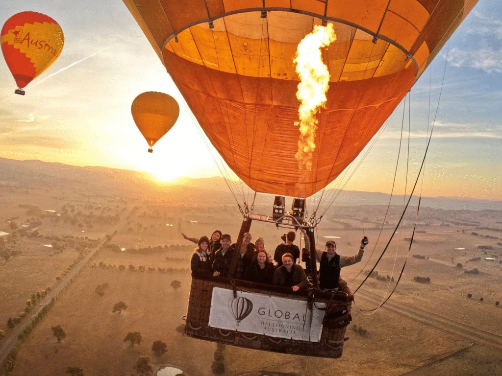 Traveler enjoying a hot air balloon Australia adventure during golden hour