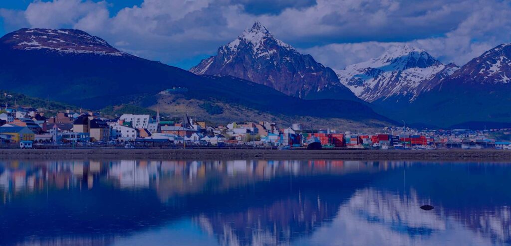 Ushuaia Argentina travel guide - panoramic view of Les Eclaireurs lighthouse in the Beagle Channel with snowy mountains