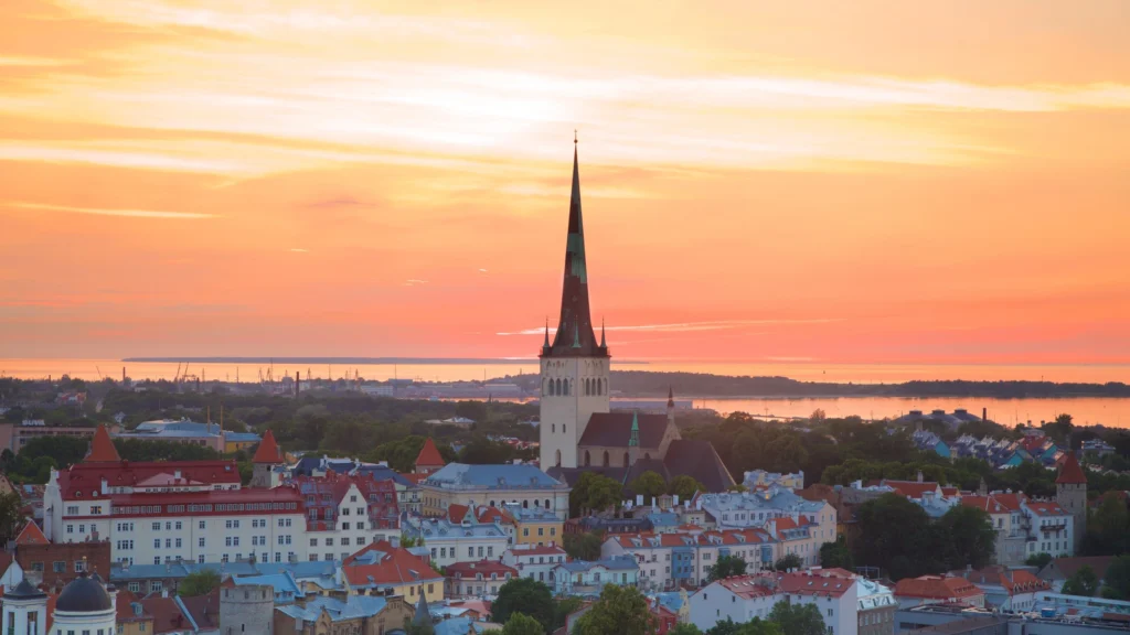 A romantic view of Pärnu, Estonia with the sandy beach, colorful spa buildings, and Baltic Sea horizon under soft summer light — perfect for a Pärnu Estonia travel guide.
