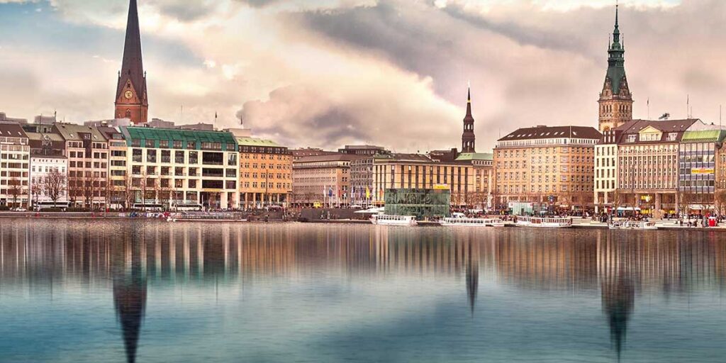 A panoramic view of Hamburg’s Speicherstadt district at sunset, showcasing historic red-brick warehouses along the canal — ideal for a Hamburg Germany travel guide