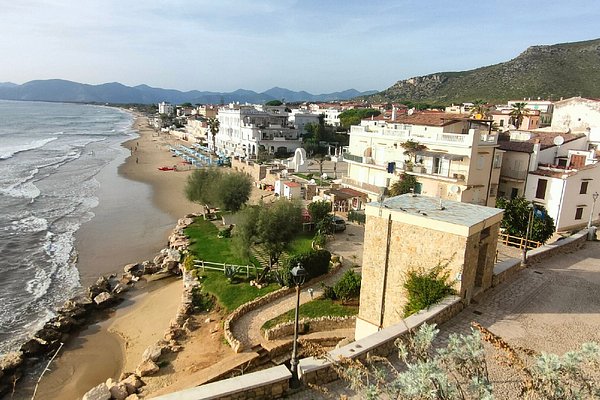 Seaside view of whitewashed houses and turquoise waters featured in a Sperlonga Italy travel guide
