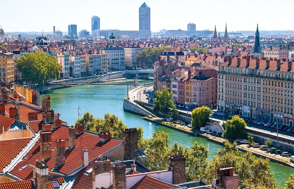 A panoramic view of Lyon’s historic riverfront with Fourvière Basilica in the background, perfect for a Lyon France travel guide.